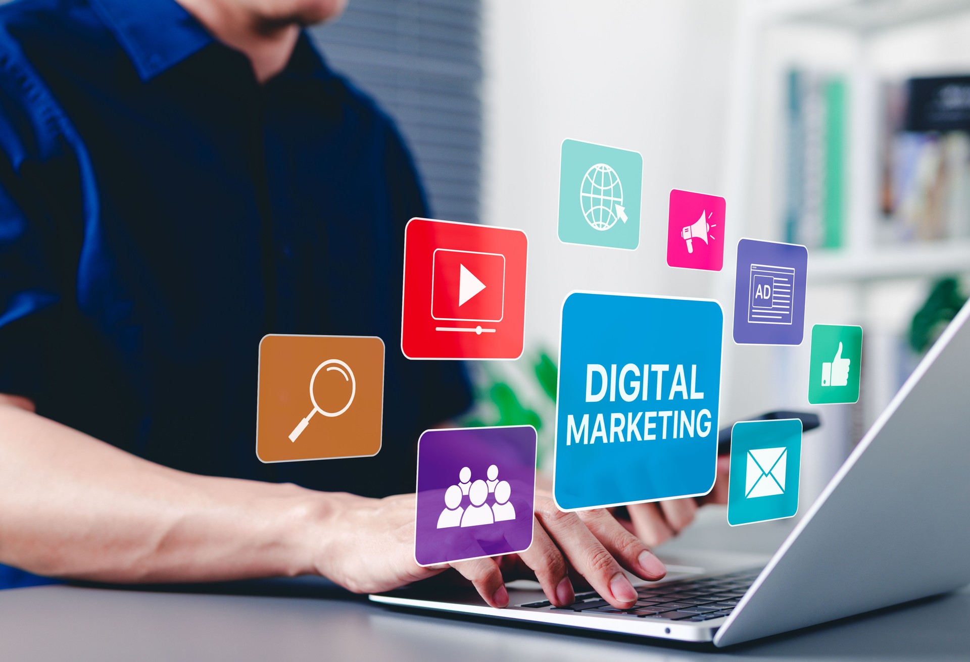 Digital Marketing Strategy Concept. A person using laptop with digital marketing icons representing SEO SEM SMM, video, email, web, advertising, ad, social media, shopping online, and analytics tools.
